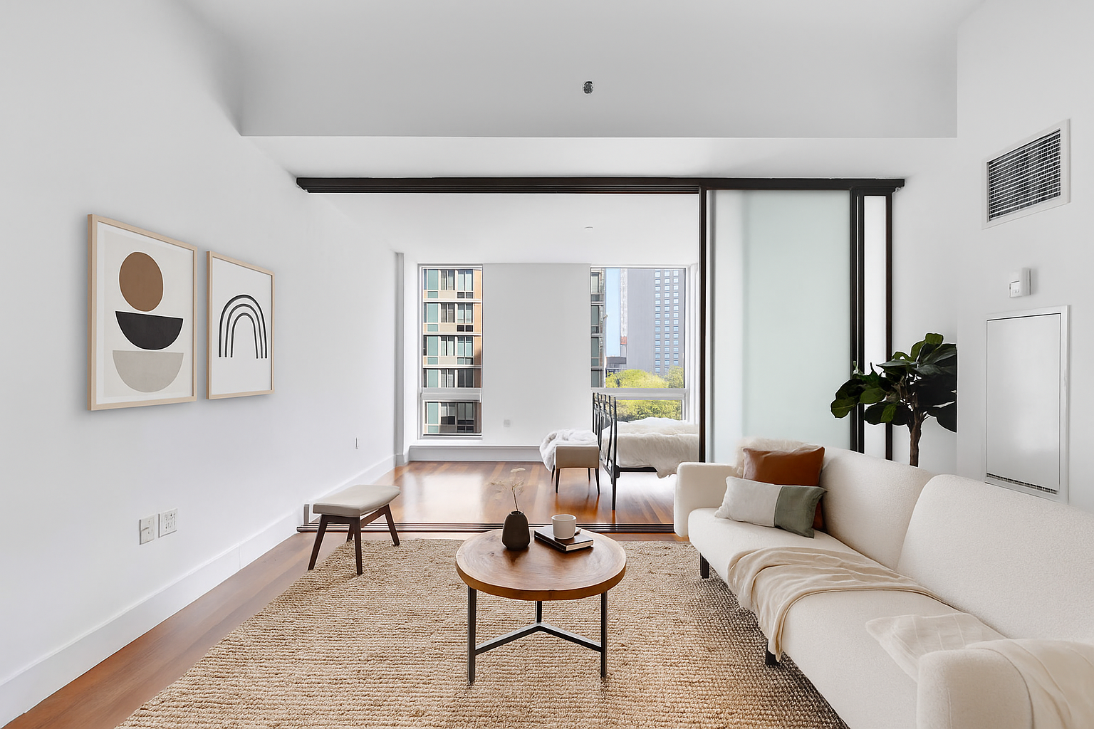 a living room with furniture and wooden floor