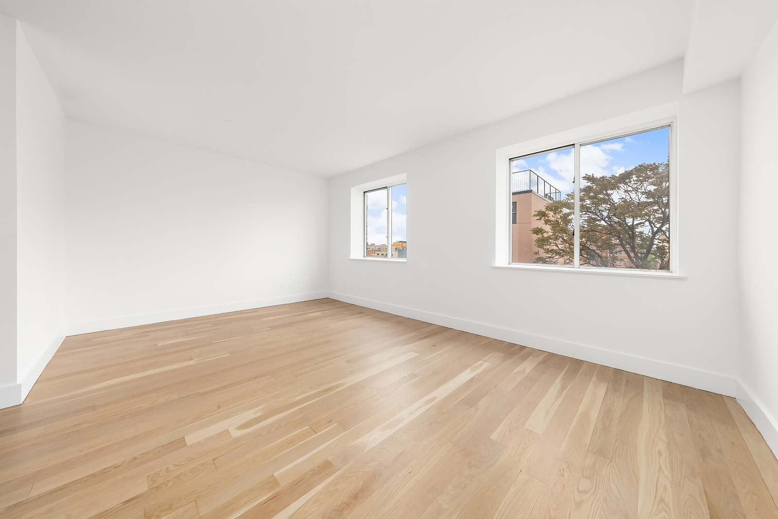201 Spencer Street, Unit 5B Brooklyn, NY 11205 - Photo 5 of 9 wooden floor in an empty room with a window