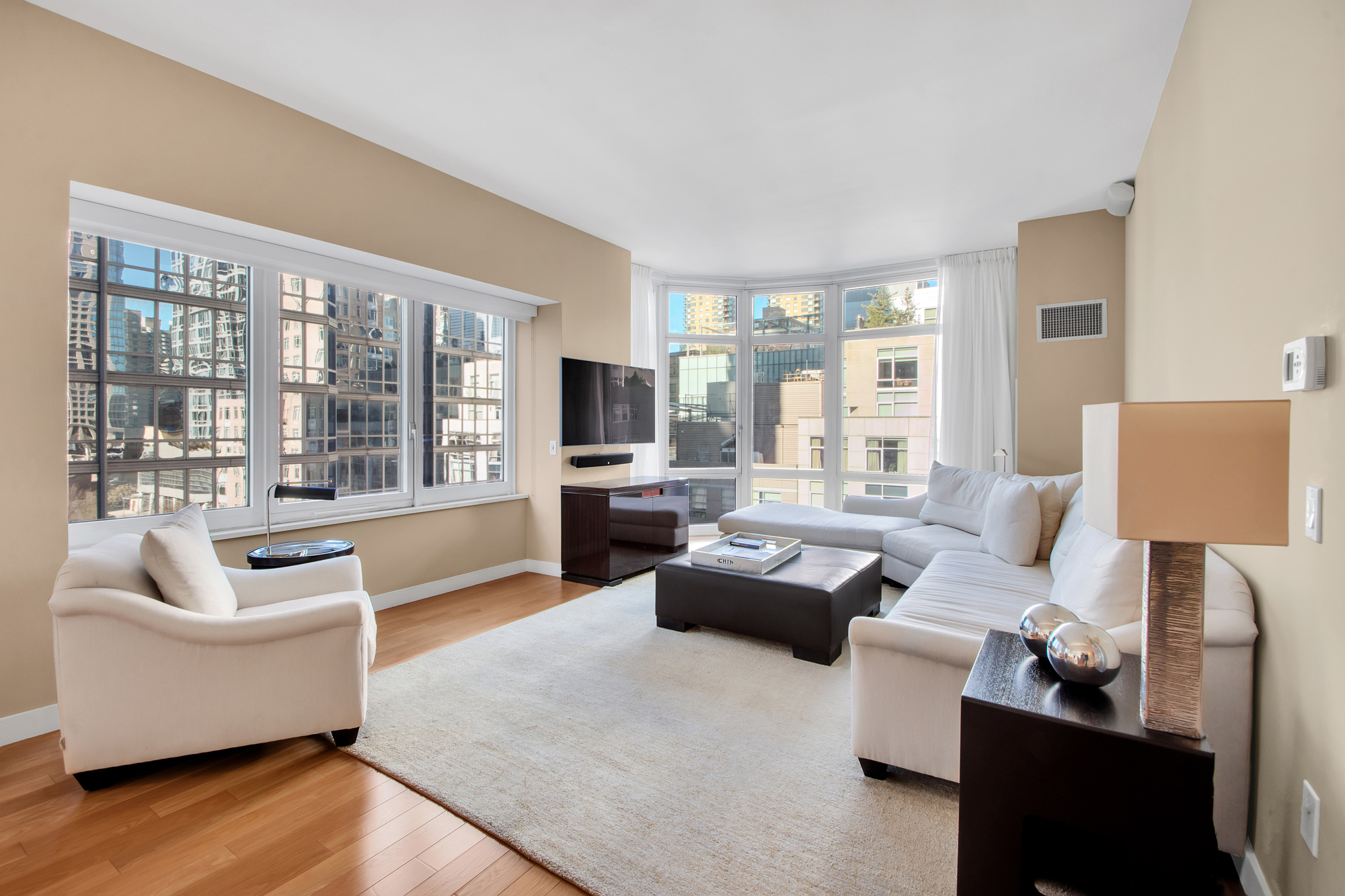 555 West 59th Street, Unit 9B Manhattan, NY 10023 - Photo 1 of 15 a living room with furniture and a large window