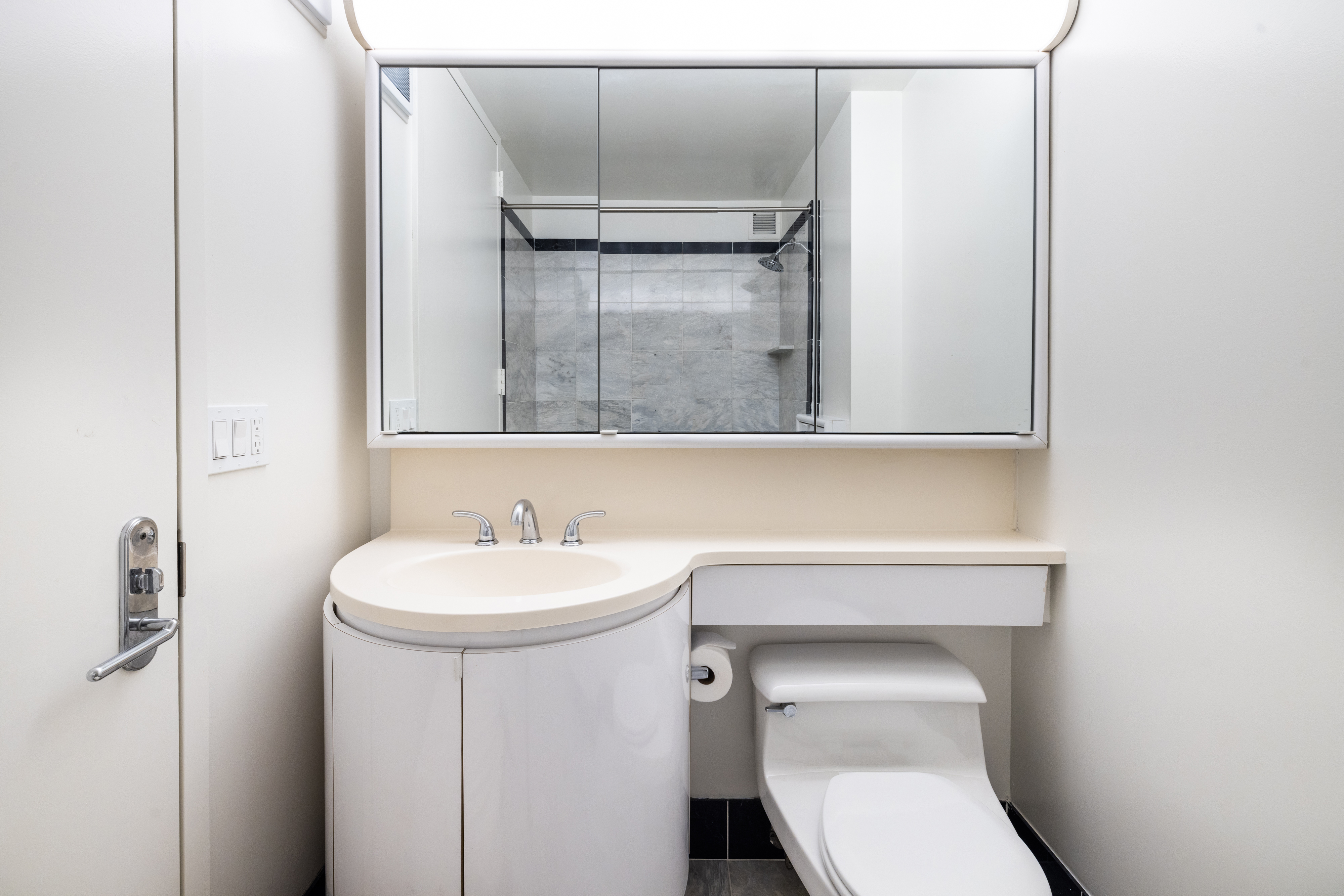 200 East 32nd Street, Unit 35C Manhattan, NY 10016 - Photo 12 of 26 a bathroom with a sink a toilet and mirror