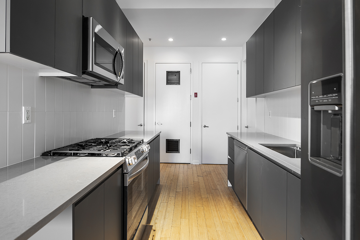 148 North 10th Street, Unit 5A Brooklyn, NY 11249 - Photo 2 of 9 a kitchen with stainless steel appliances granite countertop a stove a sink and a refrigerator