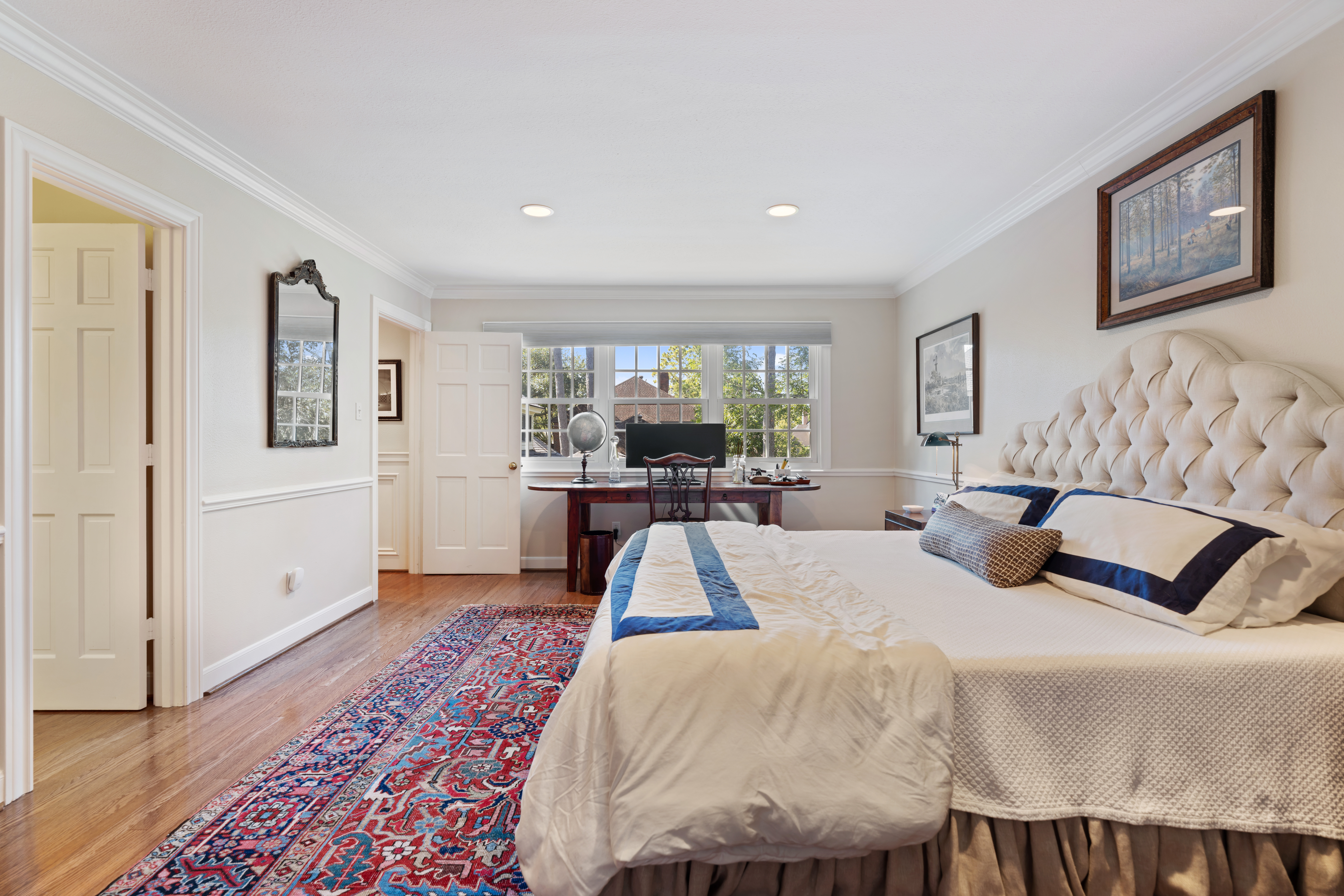 711 Pifer Road Houston, TX 77024 - Photo 41 of 53 a bedroom with a large bed and a chandelier