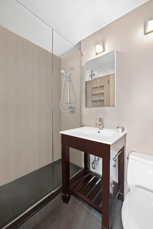 101 West 12th Street, Unit 9C Manhattan, NY 10011 - Photo 6 of 8 a bathroom with a sink a toilet and shower