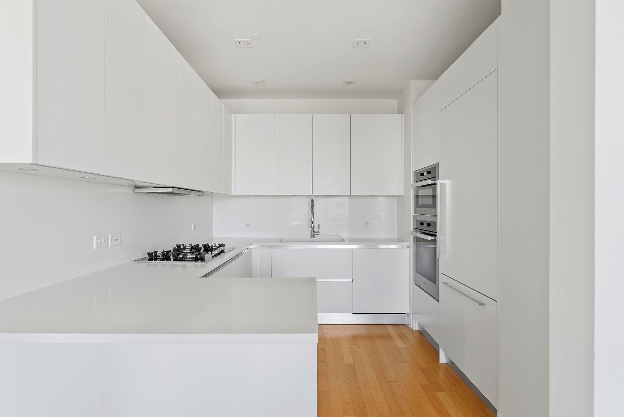 845 United Nations Plaza, Unit 63D Manhattan, NY 10017 - Photo 4 of 16 a kitchen with a sink and cabinets