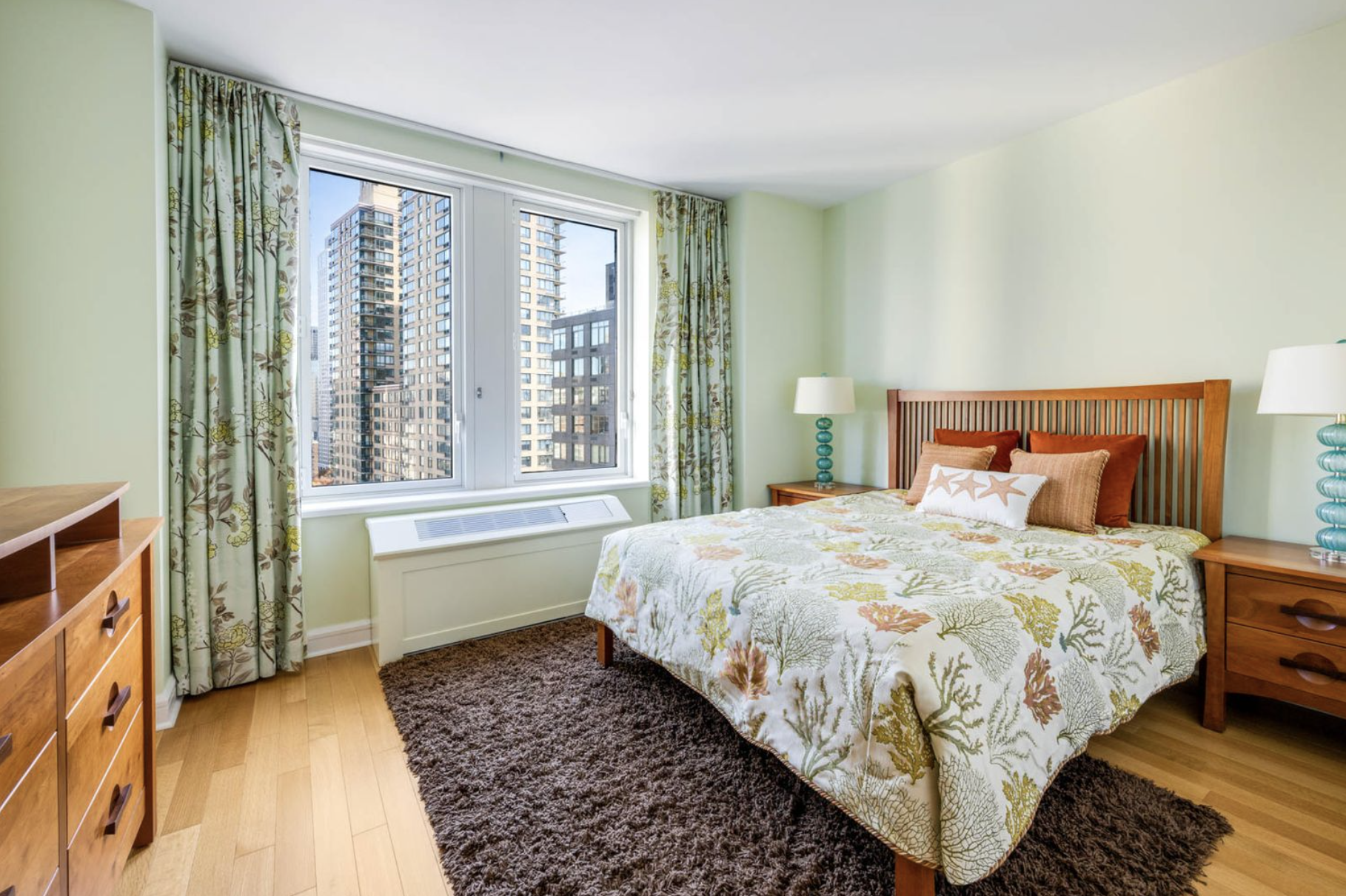 80 Riverside Boulevard, Unit 23C Manhattan, NY 10069 - Photo 10 of 19 a bedroom with a bed and a window