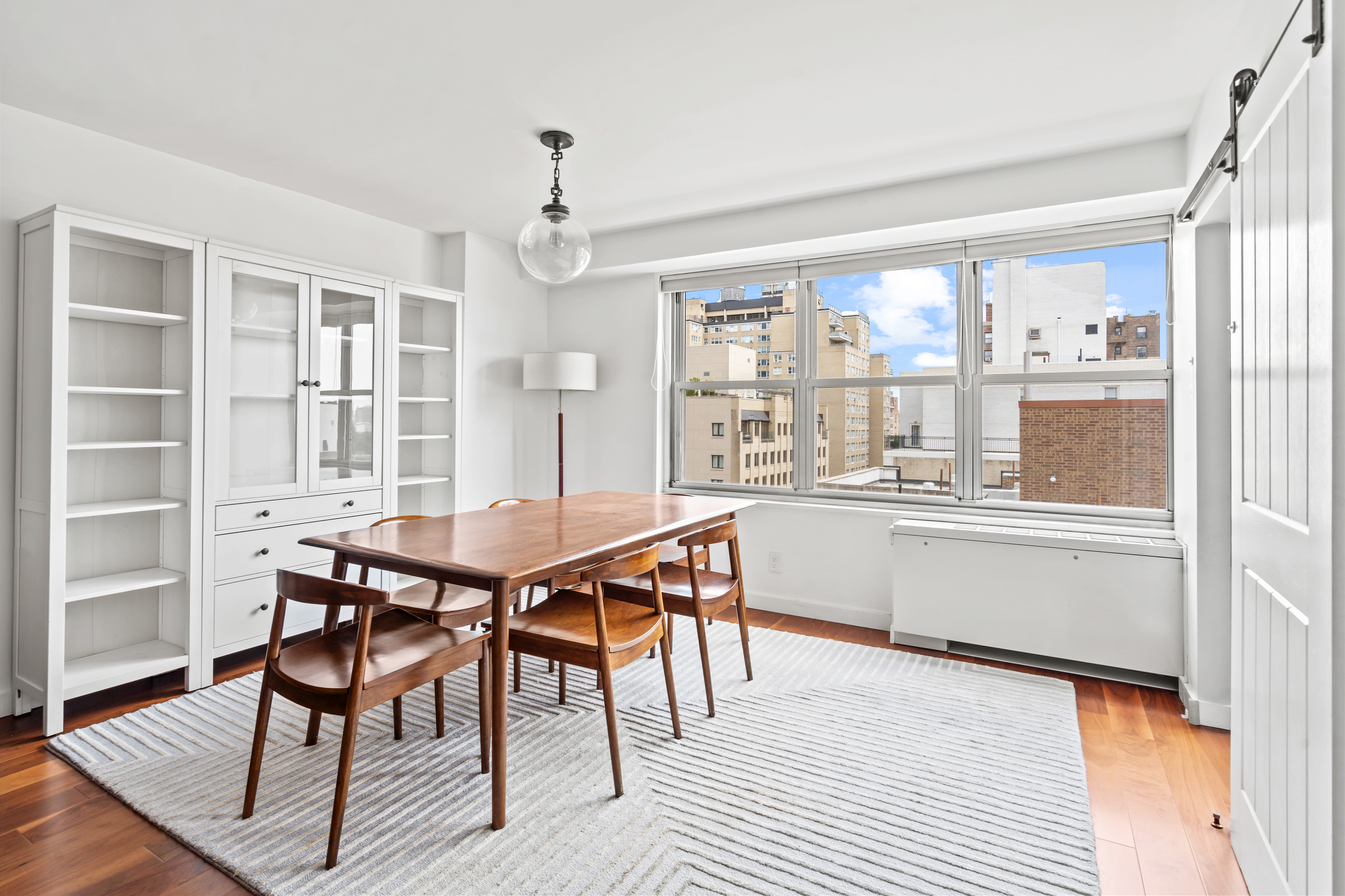 205 3rd Avenue, Unit 11T Manhattan, NY 10003 - Photo 3 of 20 a dining room with a wooden table and chairs