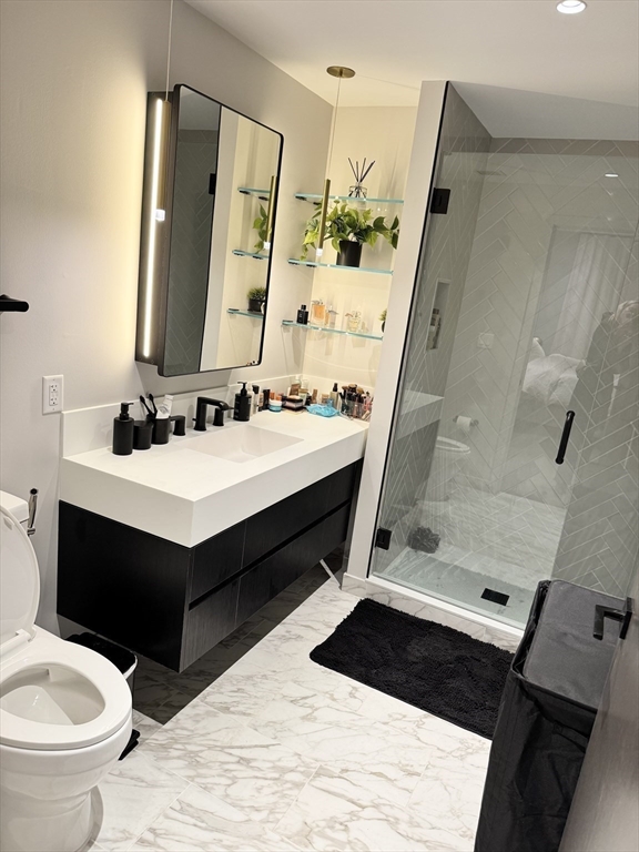 55 Lagrange Street, Unit 304 Boston, MA 02111 - Photo 13 of 15 a bathroom with a sink and a mirror