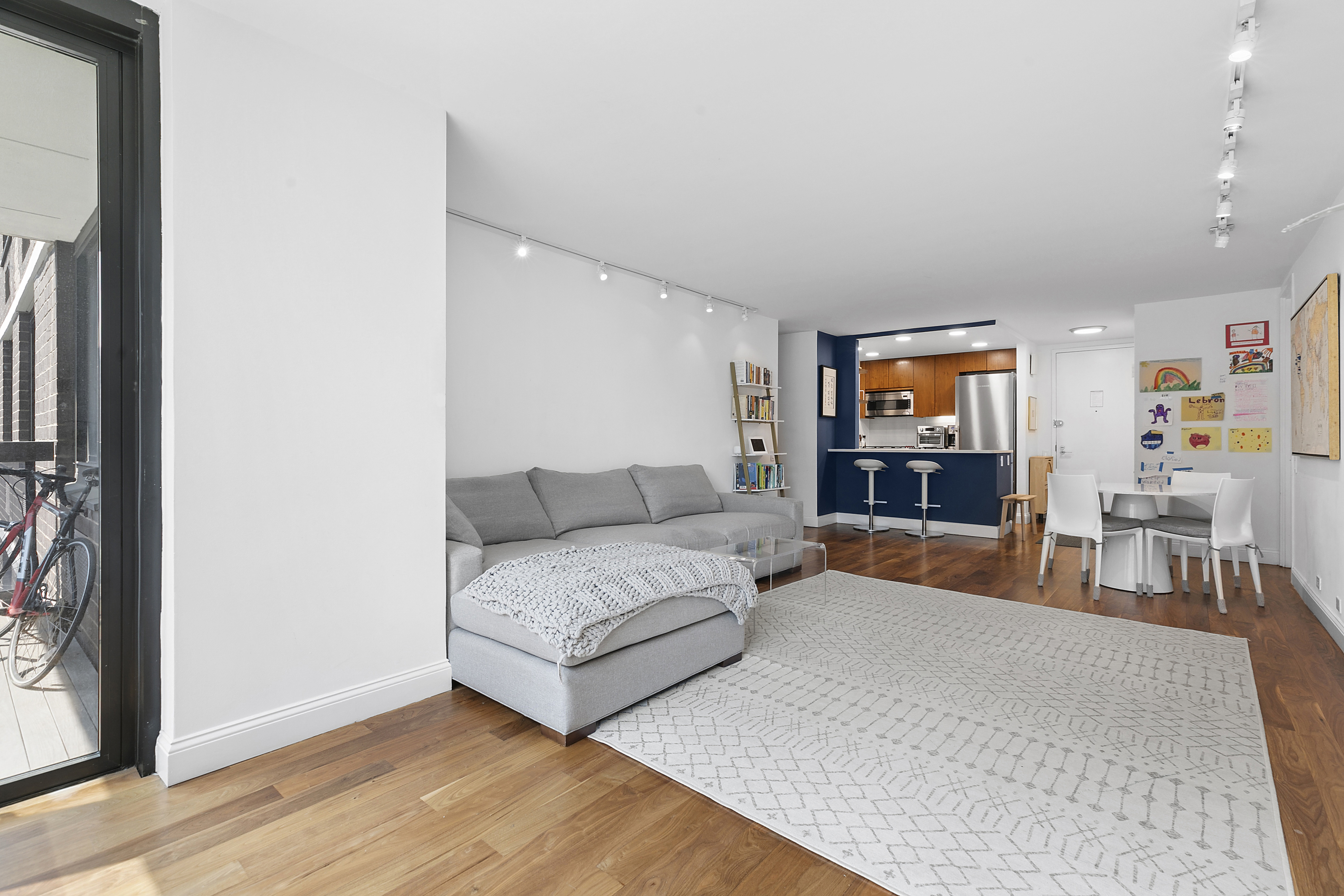 515 East 72nd Street, Unit 9J Manhattan, NY 10021 - Photo 3 of 17 a living room with furniture and a flat screen tv