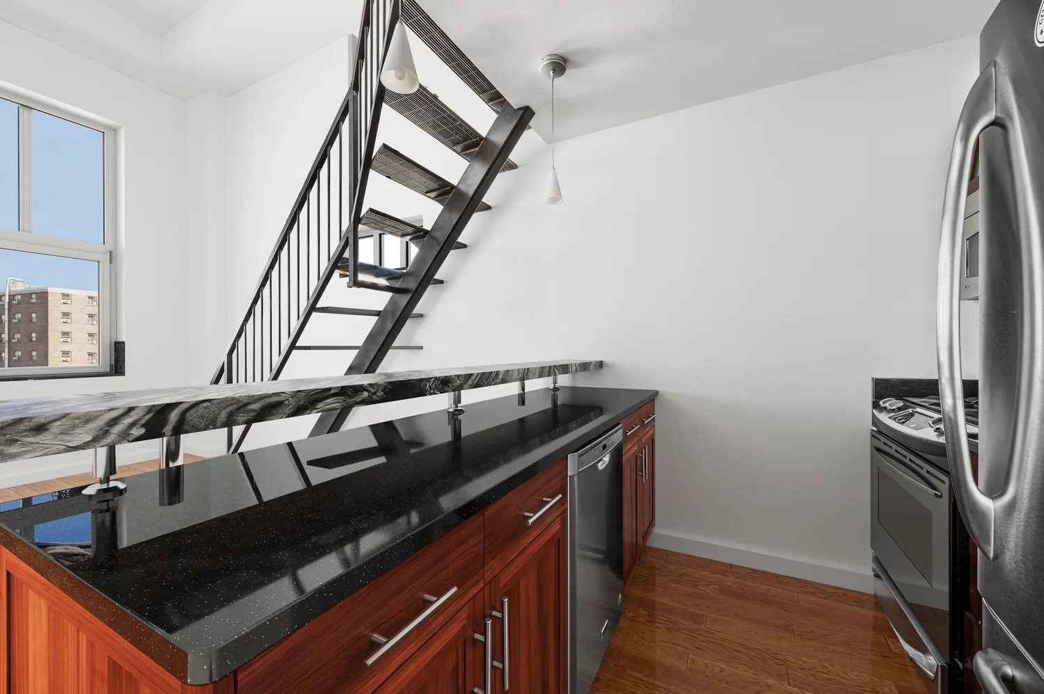 a kitchen with granite countertop a stove and a sink