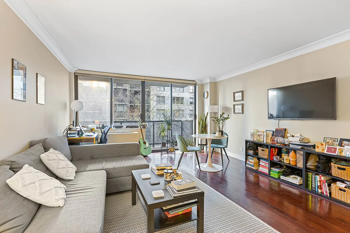 510 East 80th Street, Unit 4D Manhattan, NY 10075 - Photo 6 of 20 a living room with furniture and a flat screen tv