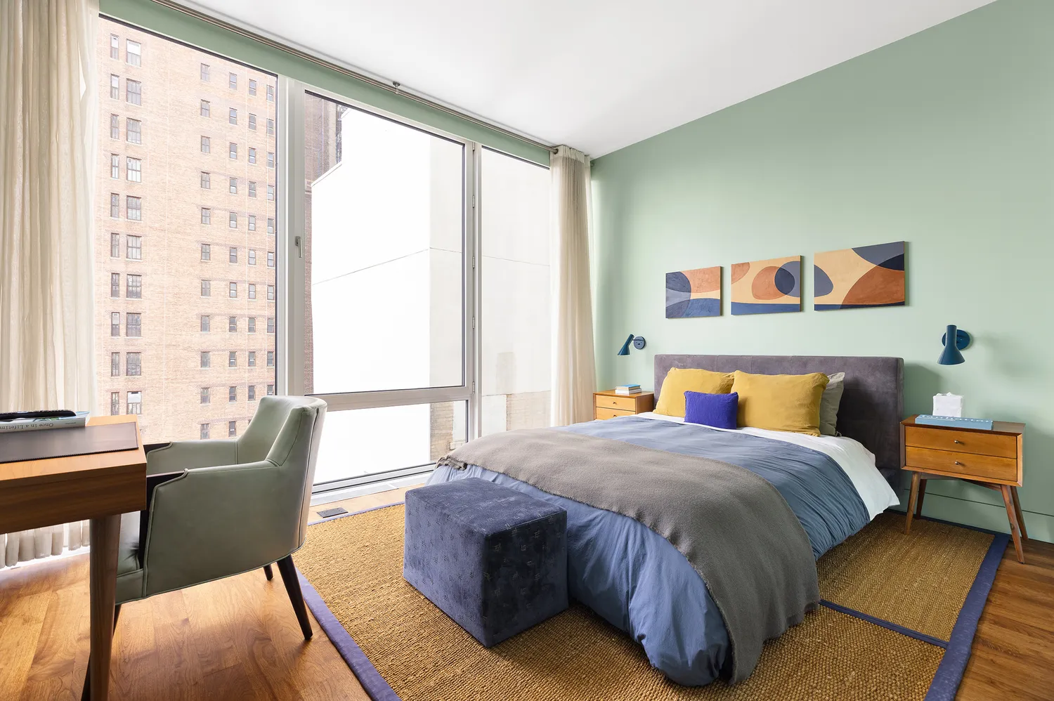 a bedroom with a bed and a couch next to a window