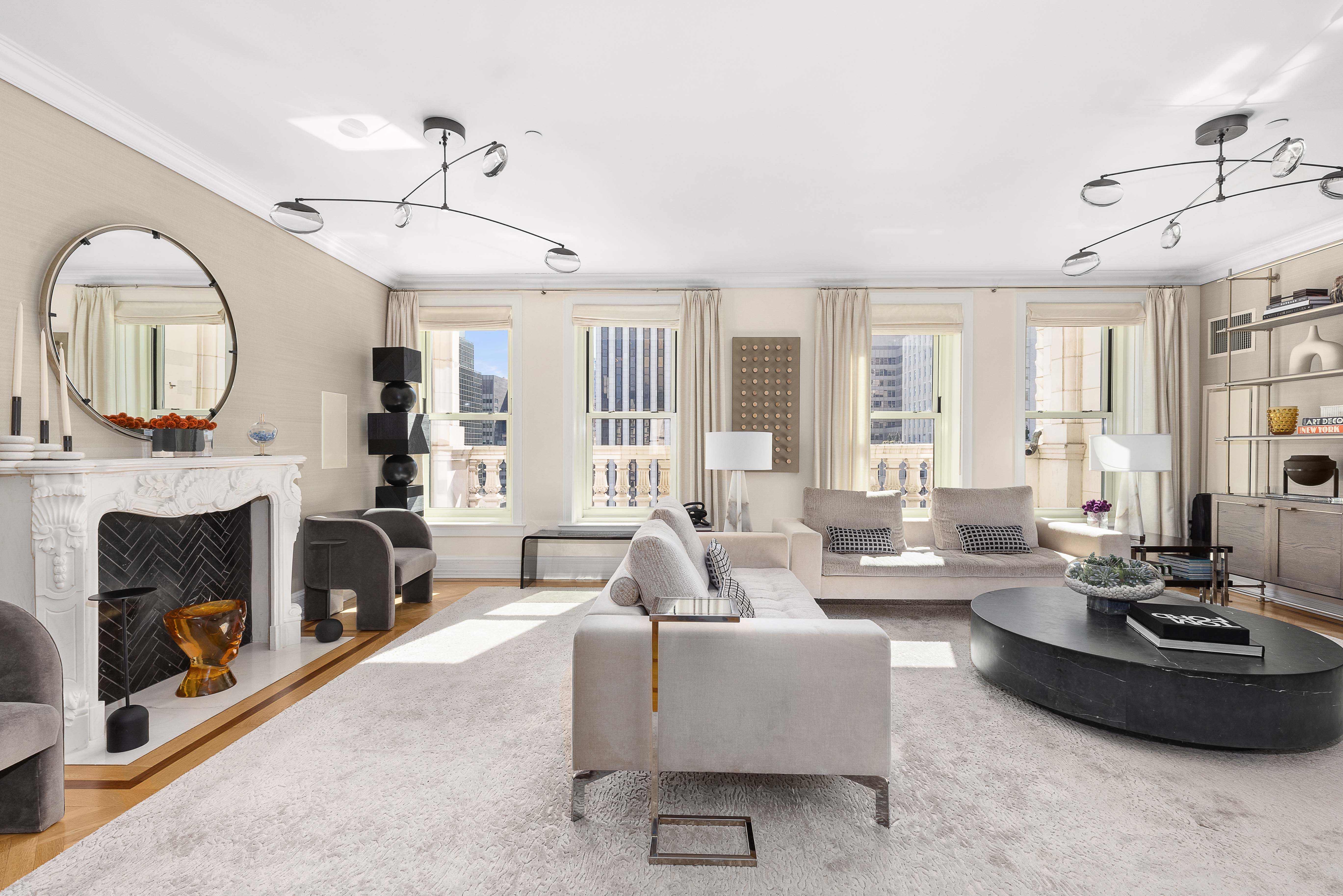 1 Central Park South, Unit 1513 Manhattan, NY 10019 - Photo 1 of 29 a living room with furniture fireplace and a large mirror