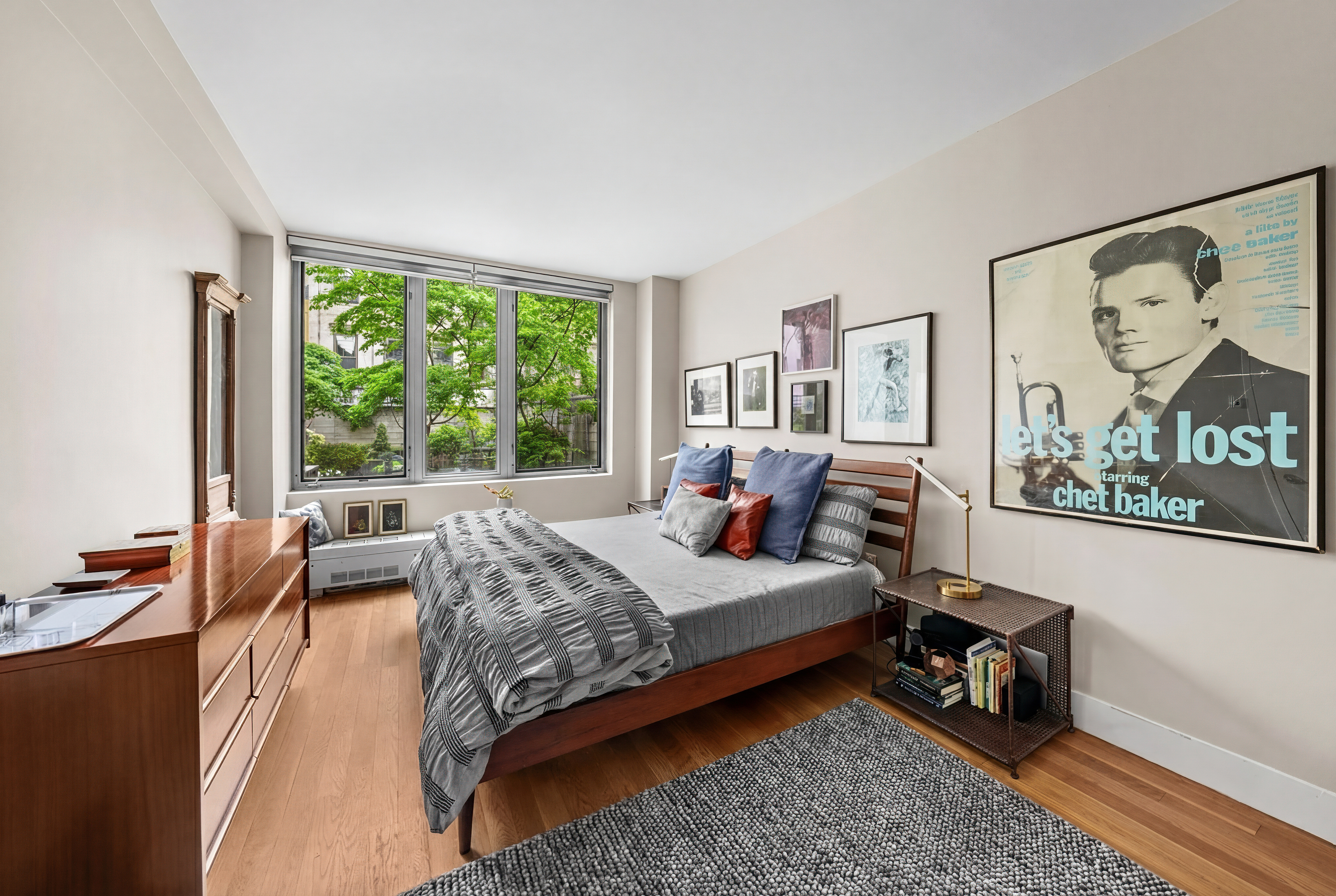 117 West 123rd Street, Unit 1B Manhattan, NY 10027 - Photo 8 of 25 a bed room with a bed and a couch