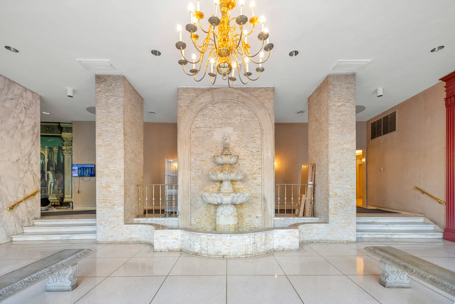 a living room with stainless steel appliances kitchen island furniture a rug and a kitchen view