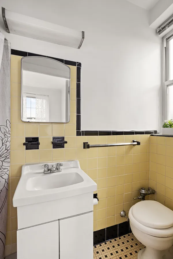 a bathroom with a sink toilet and mirror