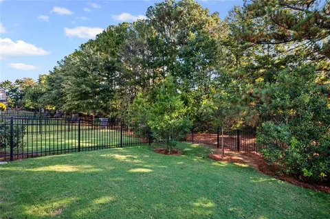 a view of a backyard with a garden and entertaining space