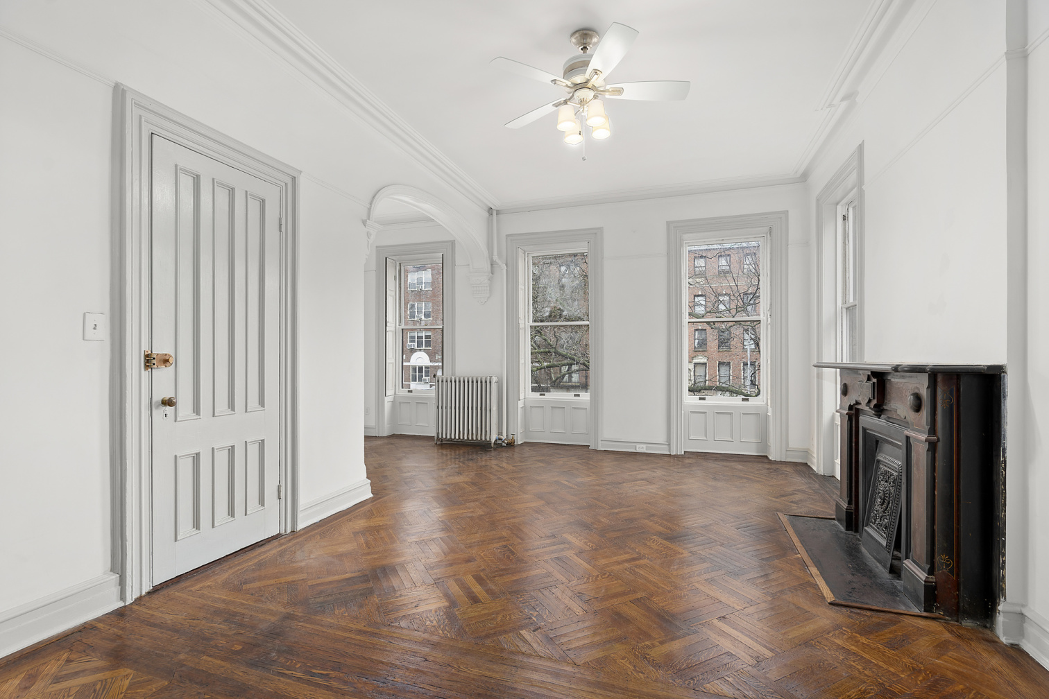 419 Clinton Avenue, Unit 2B Brooklyn, NY 11238 - Photo 2 of 7 an empty room with windows closet and fireplace