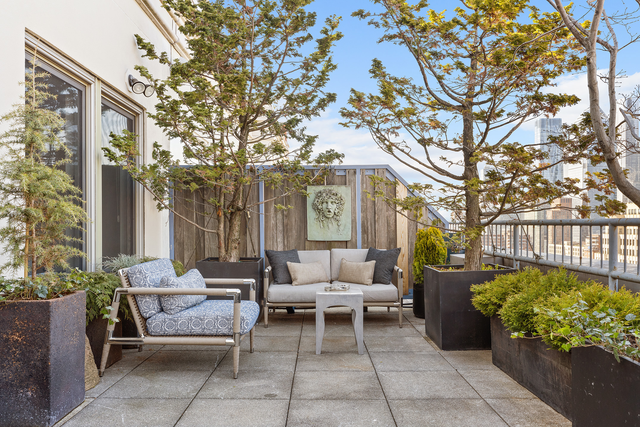 252 7th Avenue, Unit PHG Manhattan, NY 10001 - Photo 10 of 27 a view of a patio with couches and chairs under an umbrella