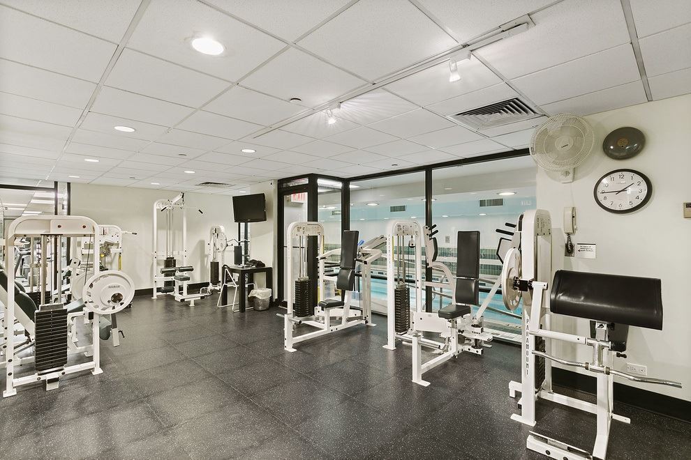 304 East 65th Street, Unit 14D Manhattan, NY 10065 - Photo 9 of 14 a view of a room with gym equipment and a large window