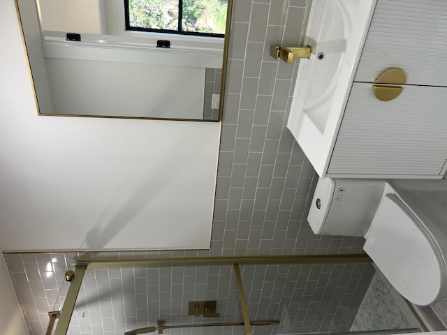 1393 Herkimer Street, Unit 2 Brooklyn, NY 11233 - Photo 6 of 9 a bathroom with a sink a toilet and shower