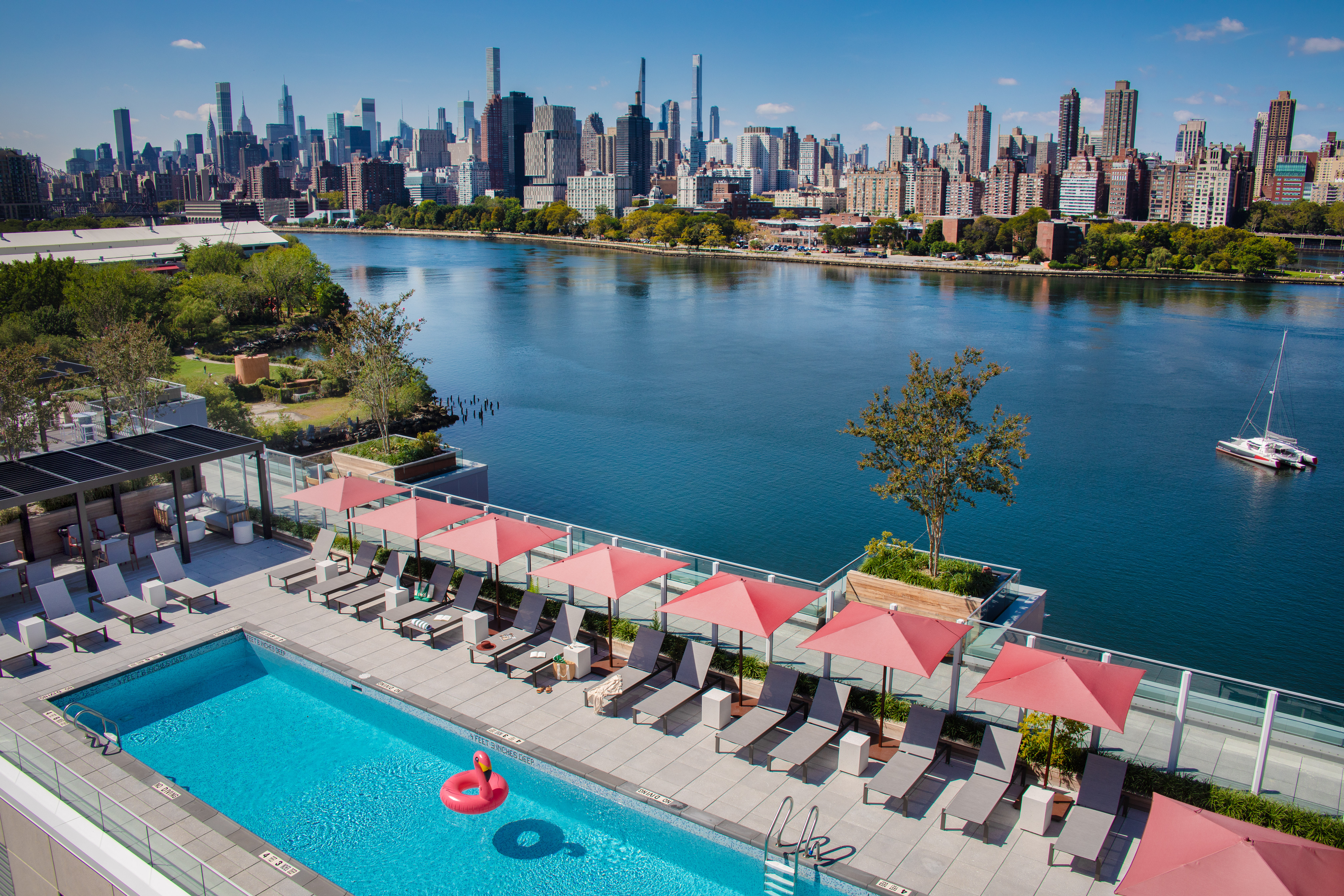 30-77 Vernon Boulevard, Unit PH736W Queens, NY 11102 - Photo 7 of 20 a view of a lake with boats and trees in the background