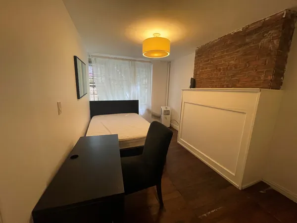 a room with a bed and a mirror