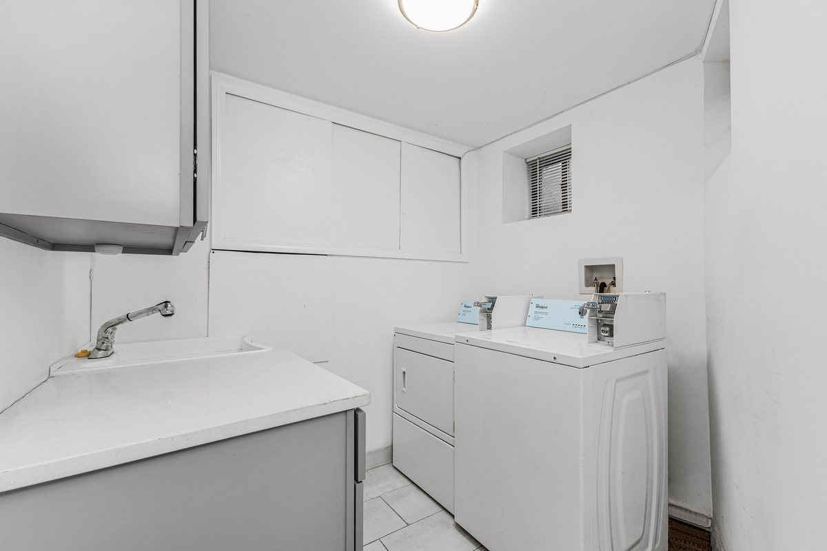 583 Evergreen Avenue Brooklyn, NY 11221 - Photo 11 of 12 a utility room with cabinets washer and dryer