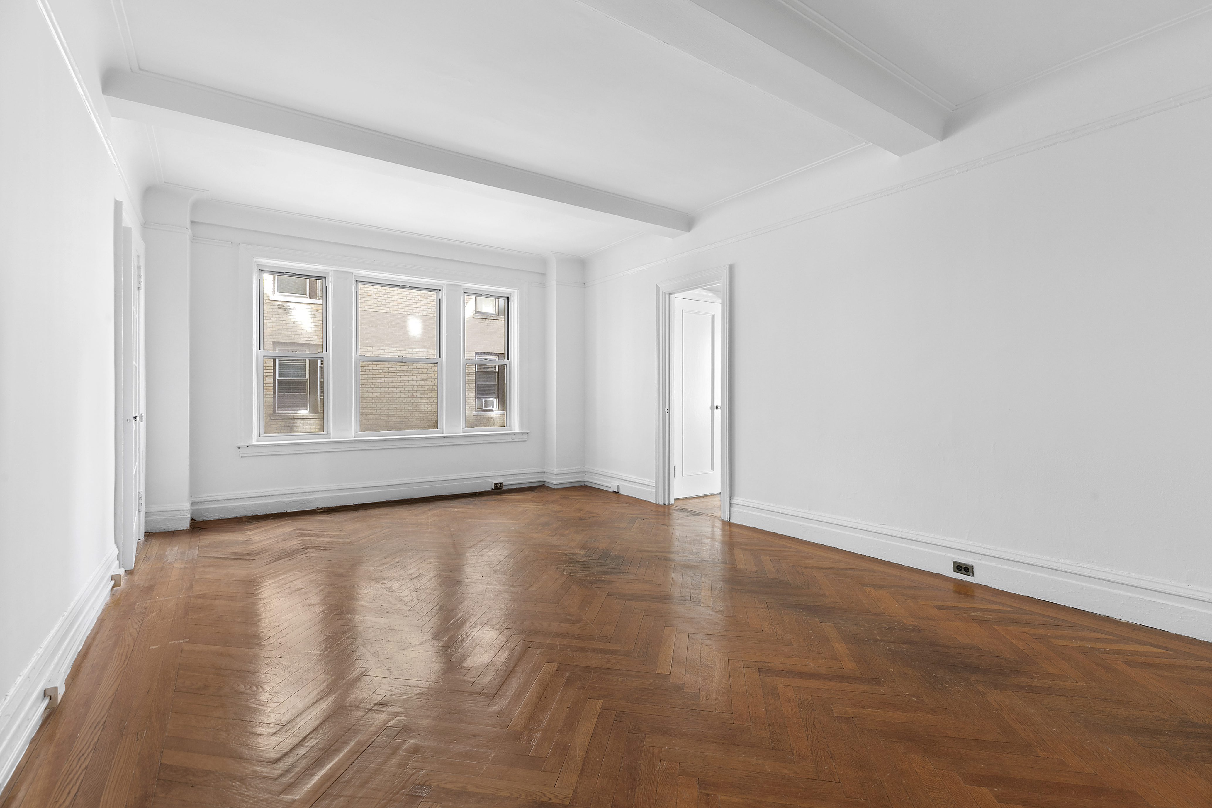 250 West 94th Street, Unit 8J Manhattan, NY 10025 - Photo 2 of 19 a view of an empty room with a window and wooden floor