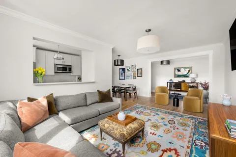 a living room with furniture and a chandelier