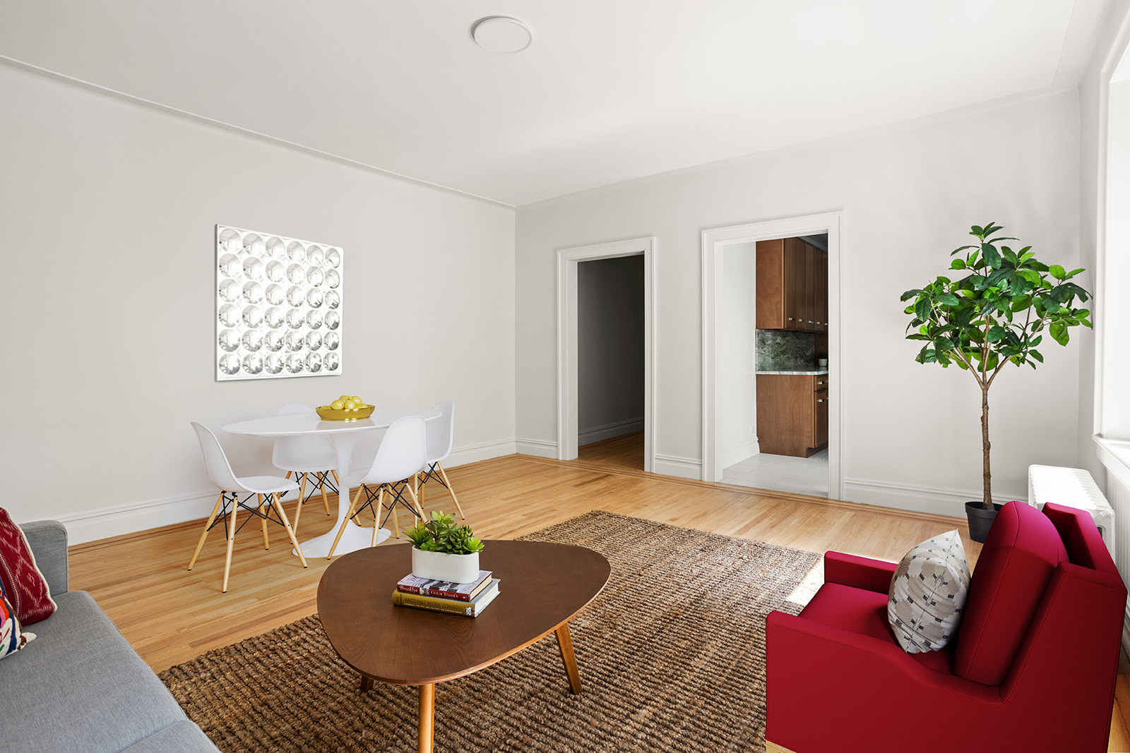83-10 35th Avenue, Unit 3F Queens, NY 11372 - Photo 2 of 13 a living room with furniture and a potted plant