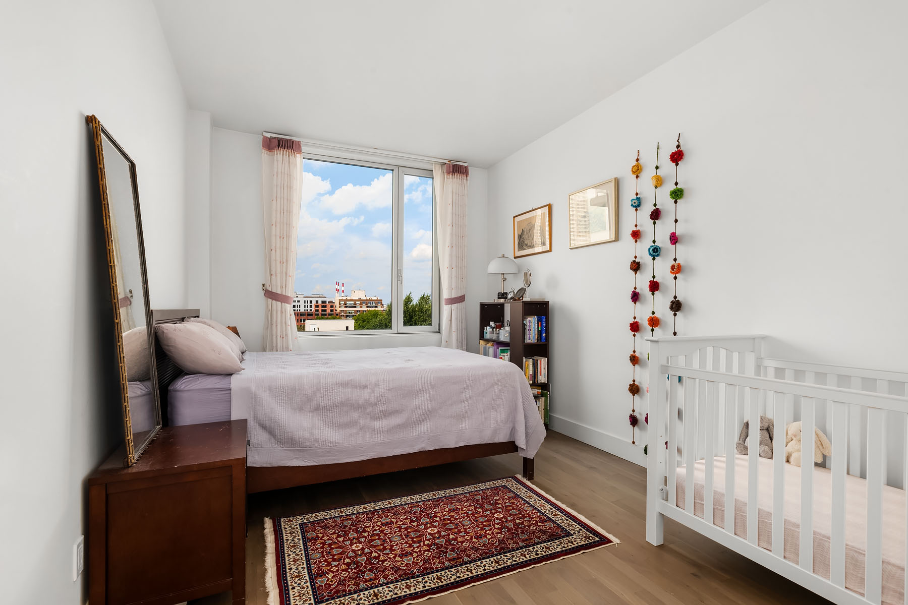 5-19 Borden Avenue, Unit 6C Queens, NY 11101 - Photo 5 of 11 a bedroom with furniture and a window