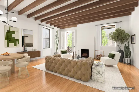 a living room with furniture fireplace and window