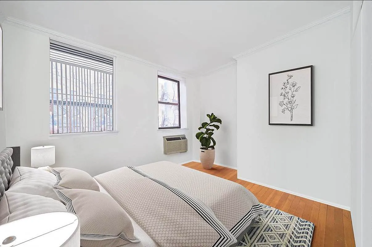 103 West 105th Street, Unit 2A Manhattan, NY 10025 - Photo 3 of 10 a bedroom with a bed painting on wall and a window