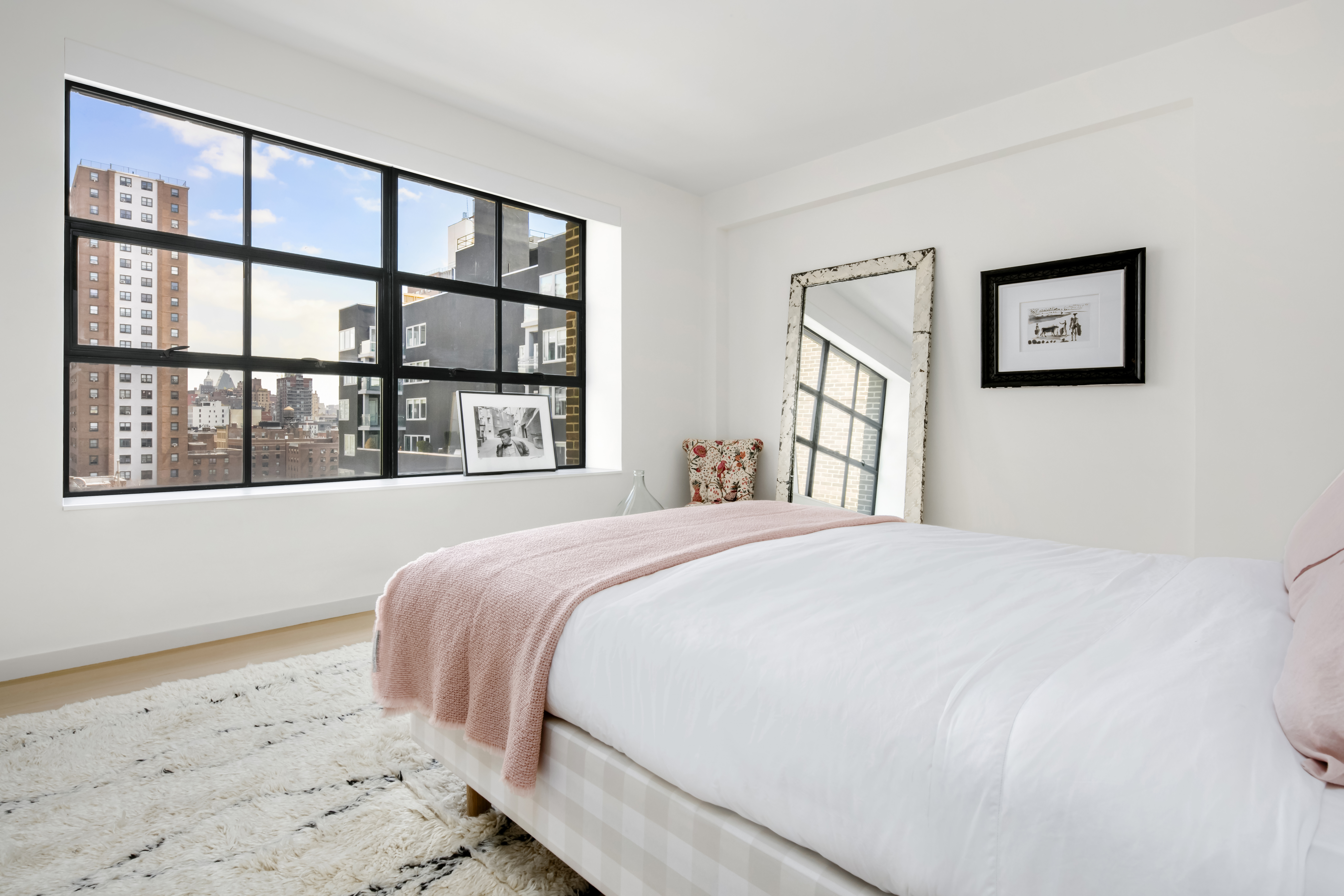 456 West 19th Street, Unit PHH Manhattan, NY 10011 - Photo 10 of 15 a bedroom with a large bed and a window