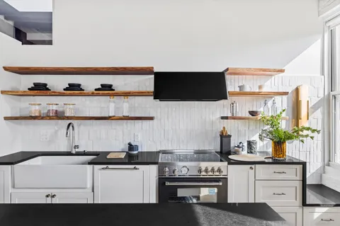 a kitchen with stainless steel appliances a sink and a stove