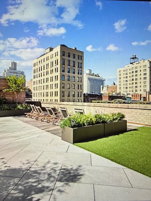 40 East 94th Street, Unit 6F Manhattan, NY 10128 - Photo 10 of 17 a front view of a building with garden