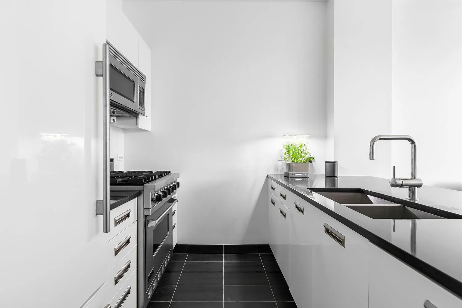 a kitchen with a sink and stainless steel appliances
