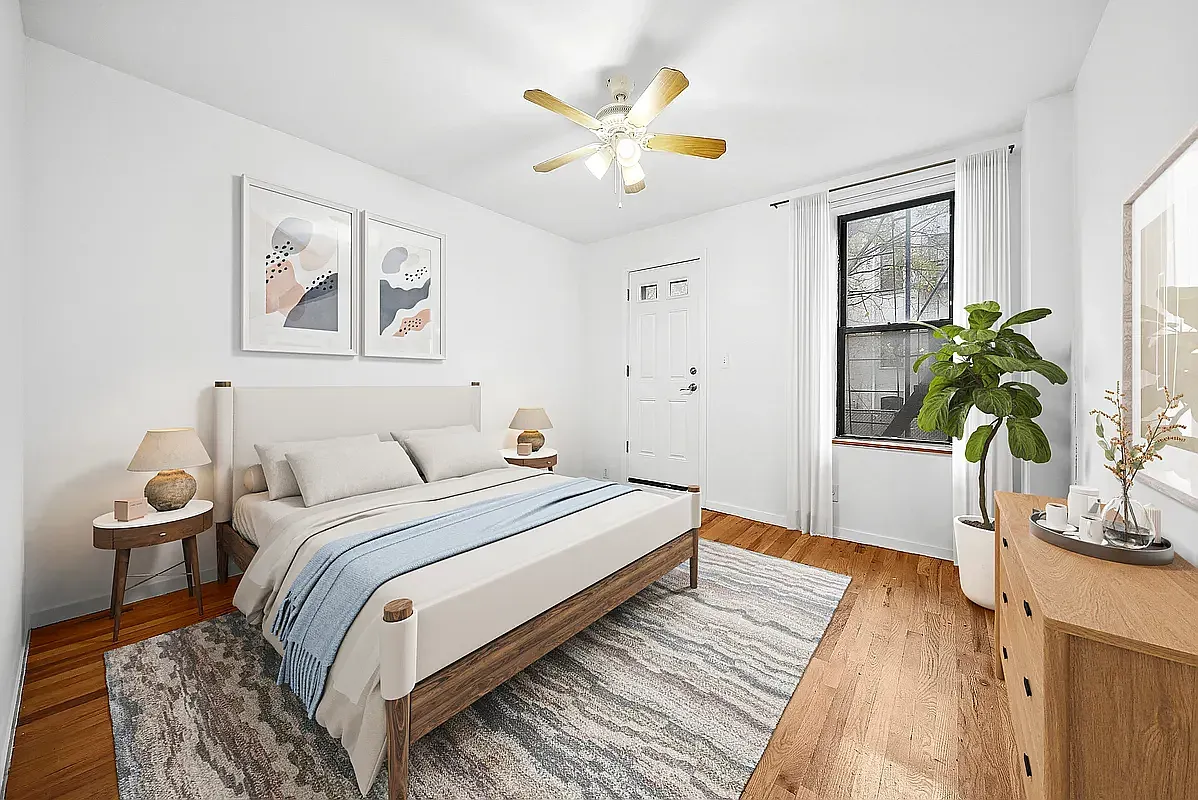 a bedroom with a bed and a potted plant