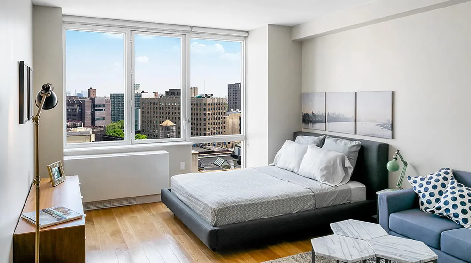 a bedroom with a bed and a couch