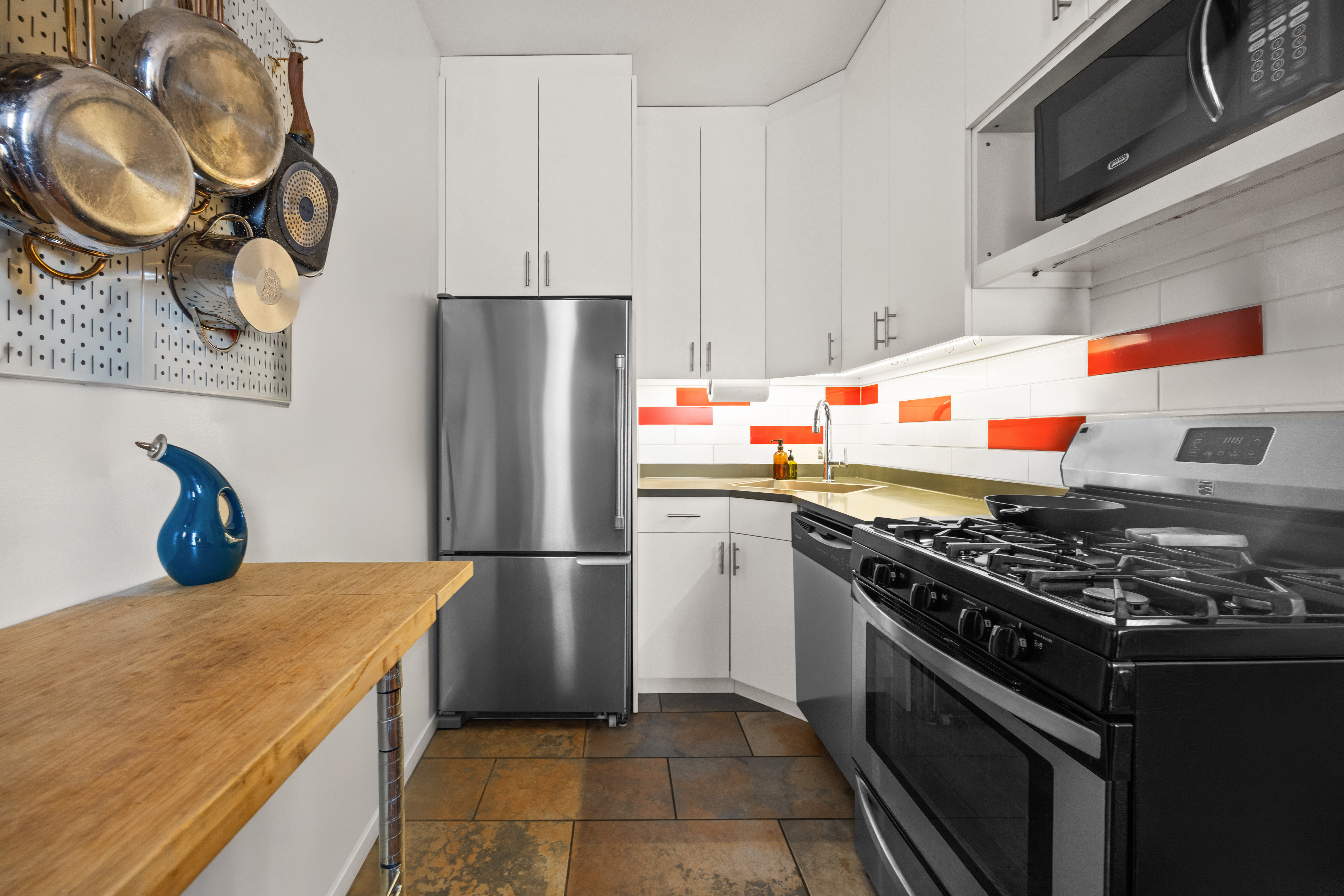 44 Turner Place, Unit 2 Brooklyn, NY 11218 - Photo 3 of 9 a kitchen with stainless steel appliances granite countertop a stove and a refrigerator