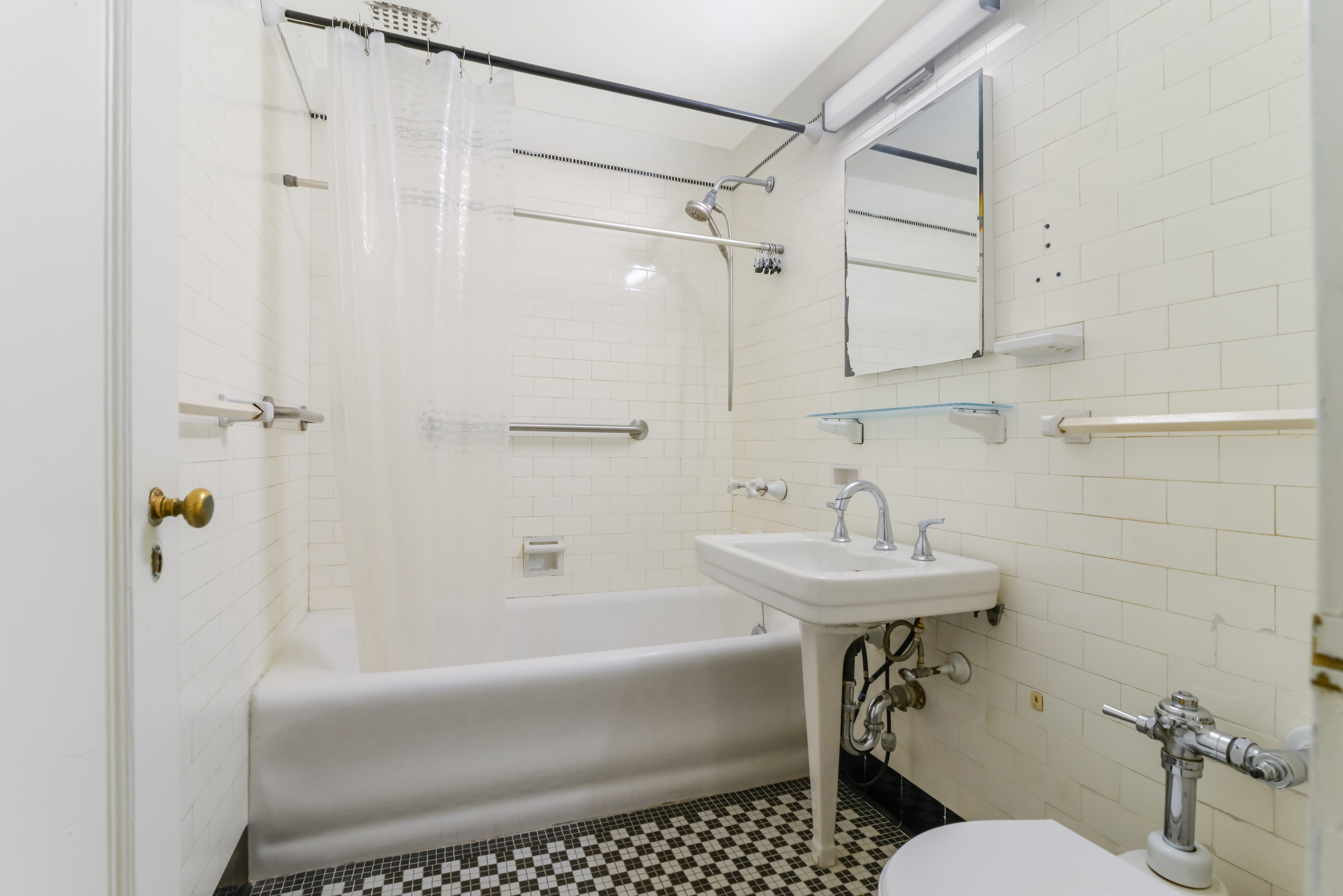 201 West 16th Street, Unit 3C Manhattan, NY 10011 - Photo 6 of 11 a bathroom with a sink toilet and shower