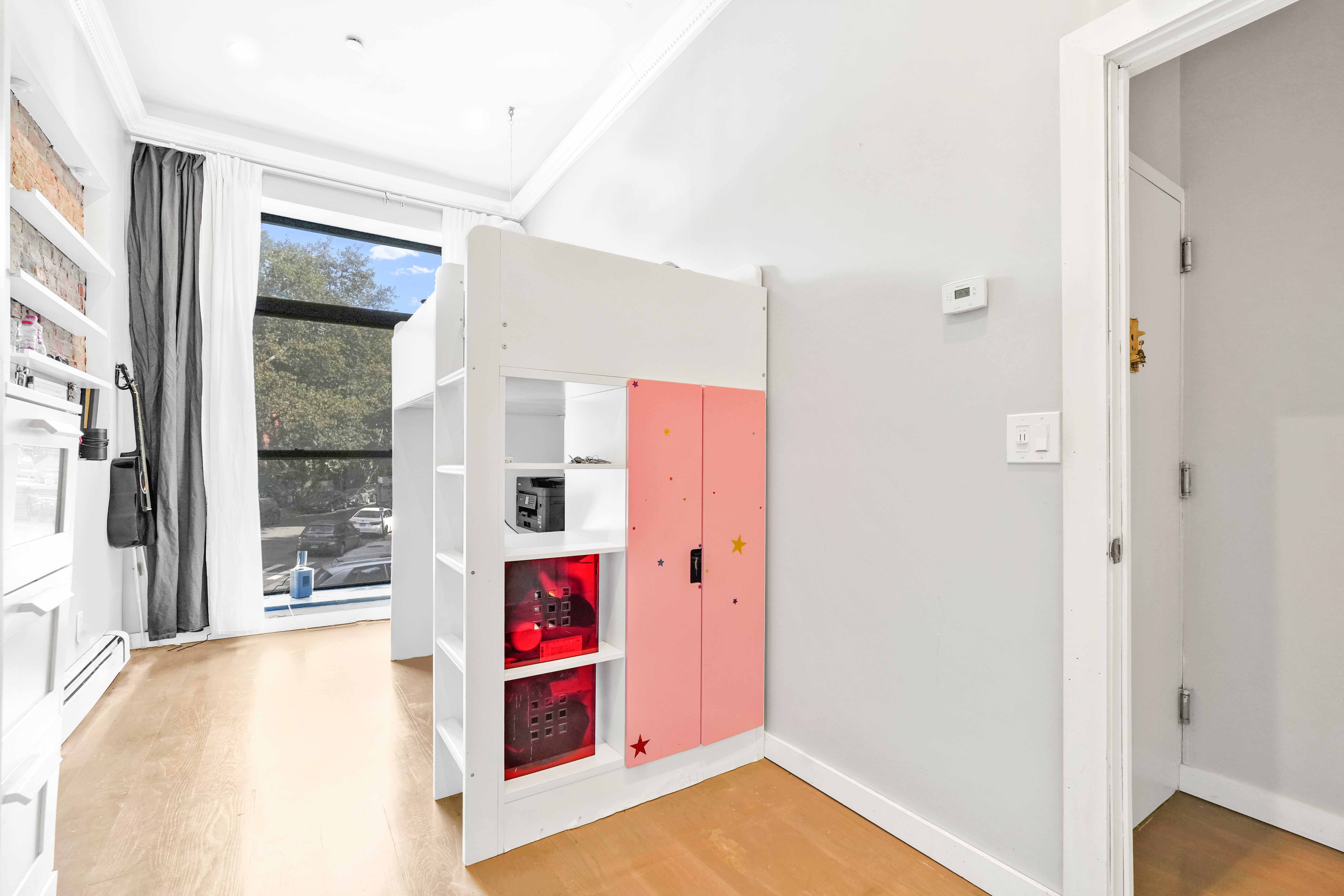288 St James Place, Unit TRIPLEX Brooklyn, NY 11238 - Photo 18 of 25 a bed room with a bed and a painting on the wall