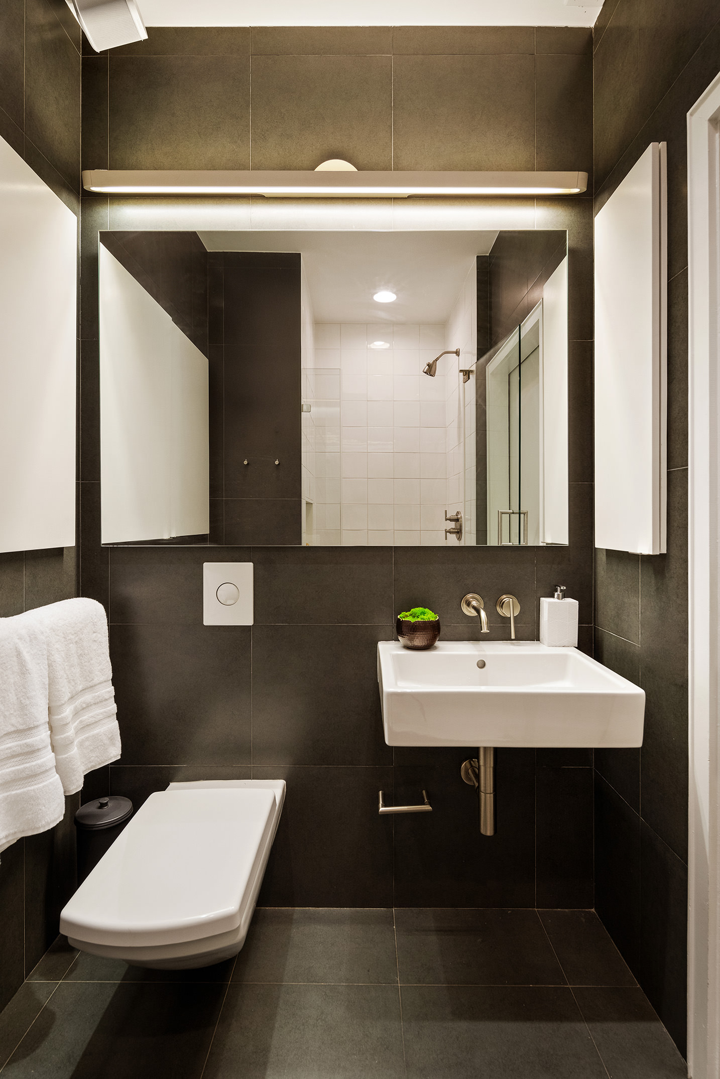 142 5th Avenue, Unit 2 Manhattan, NY 10011 - Photo 16 of 18 a bathroom with a sink and a mirror