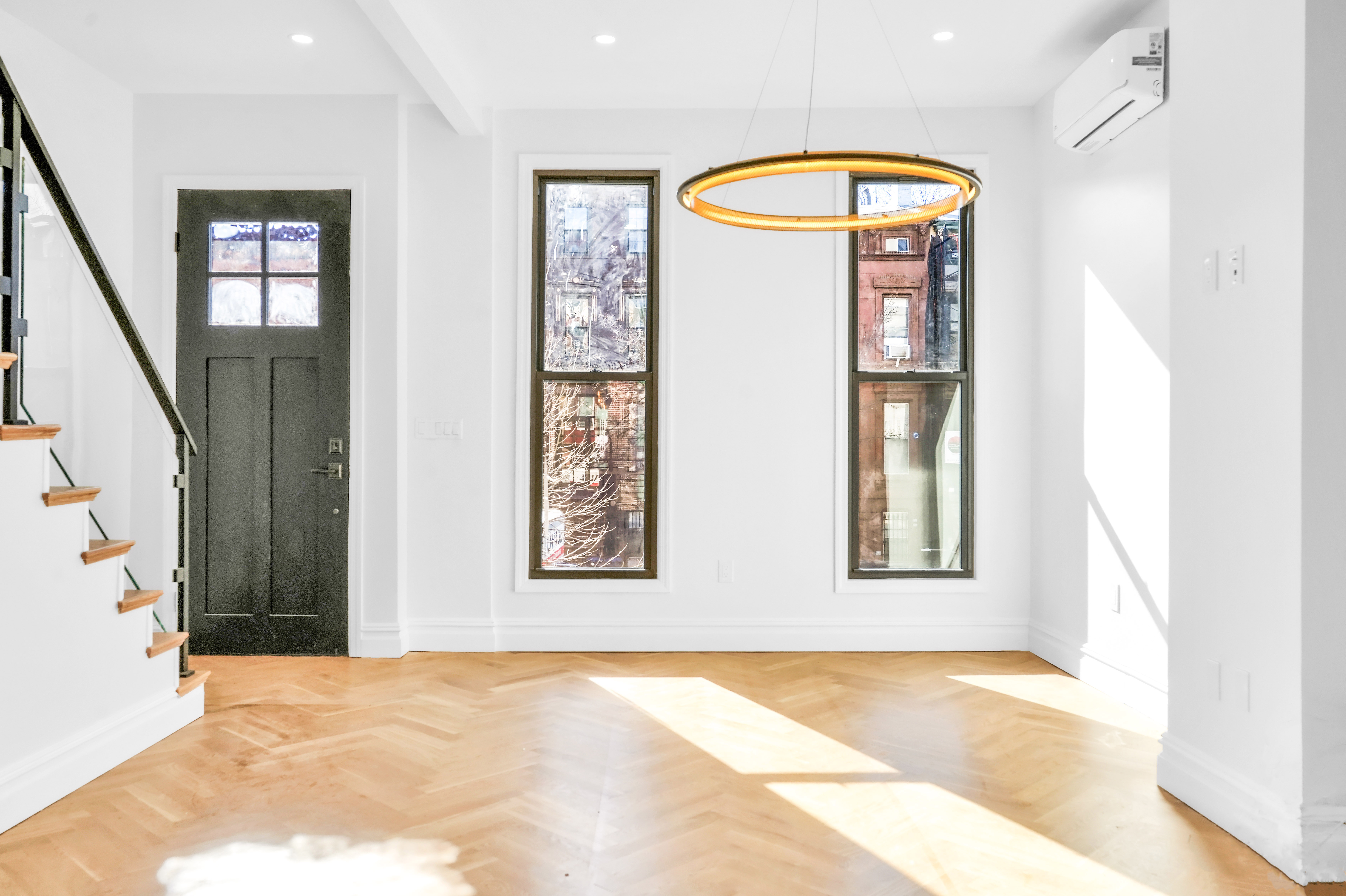 473 Monroe Street Brooklyn, NY 11221 - Photo 16 of 40 an empty room with windows and wooden floor