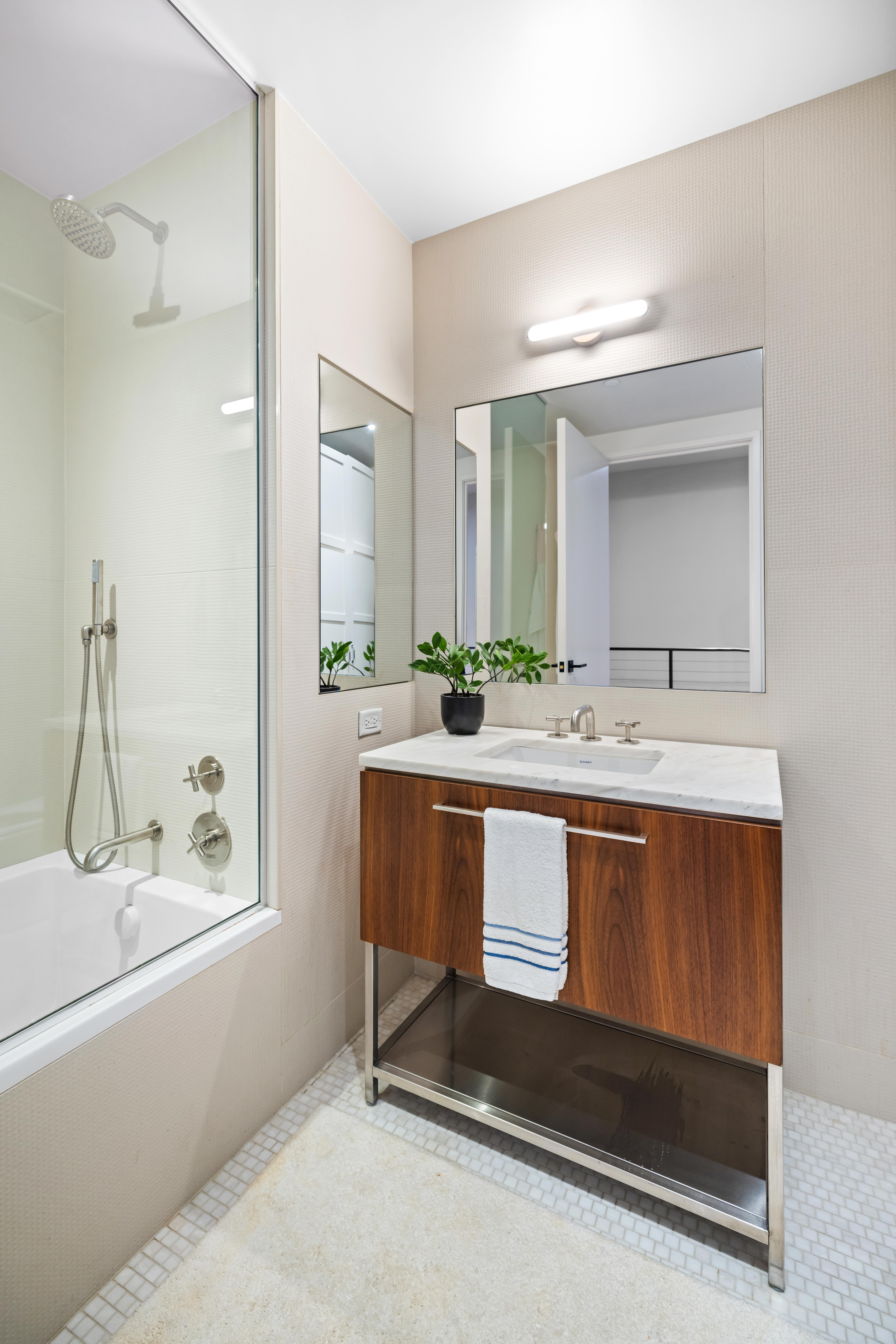 130 Furman Street, Unit S102 Brooklyn, NY 11201 - Photo 12 of 26 a bathroom with a sink double vanity and a mirror