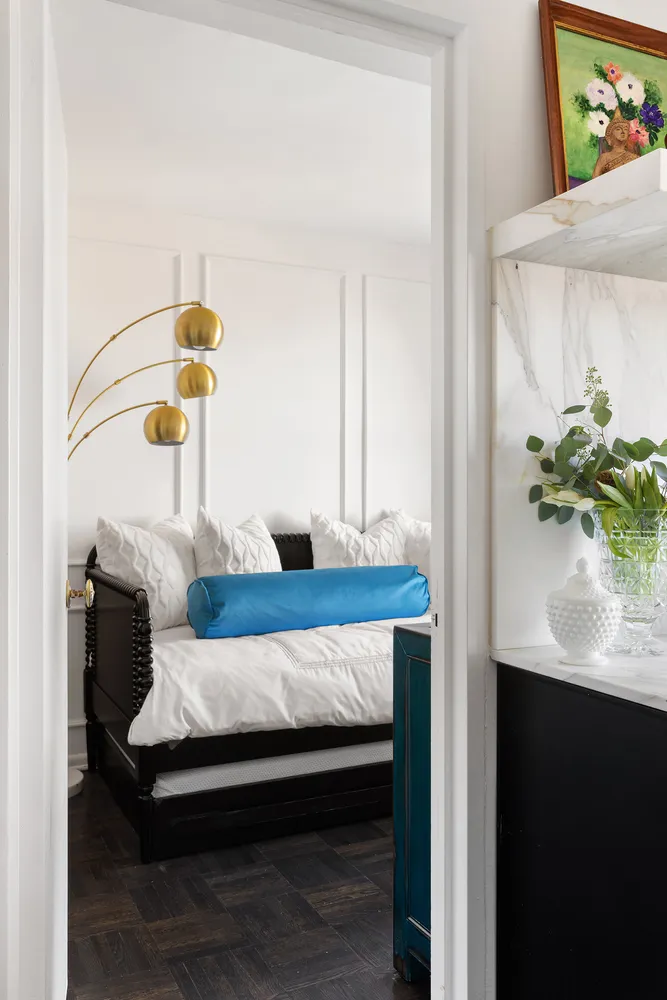 a bedroom with a bed and a potted plant