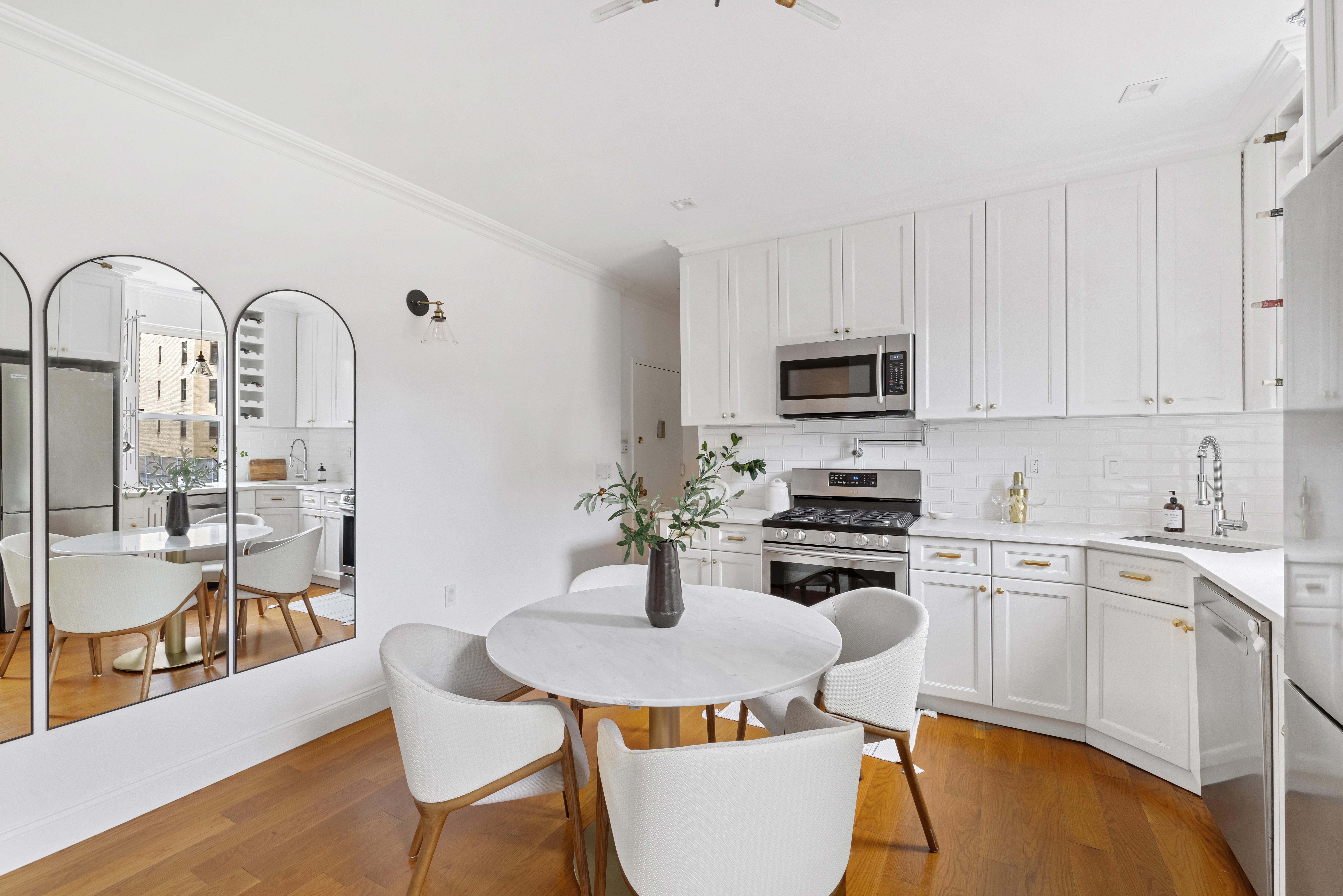 328 West 96th Street, Unit 2C Manhattan, NY 10025 - Photo 4 of 15 a kitchen with sink a stove and white cabinets