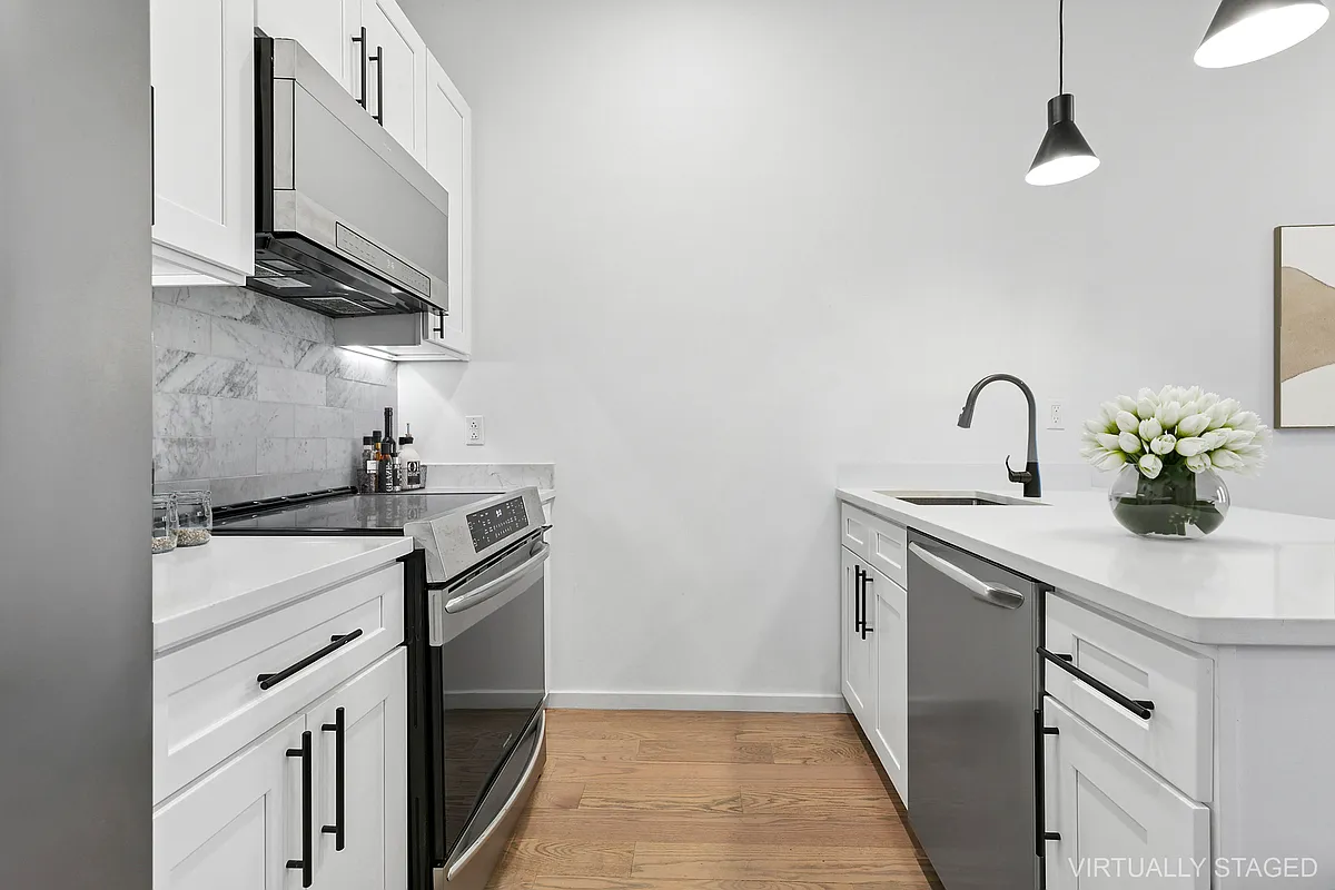 204 Smith Street, Unit 3R Brooklyn, NY 11201 - Photo 3 of 7 a kitchen with a sink stainless steel appliances and cabinets