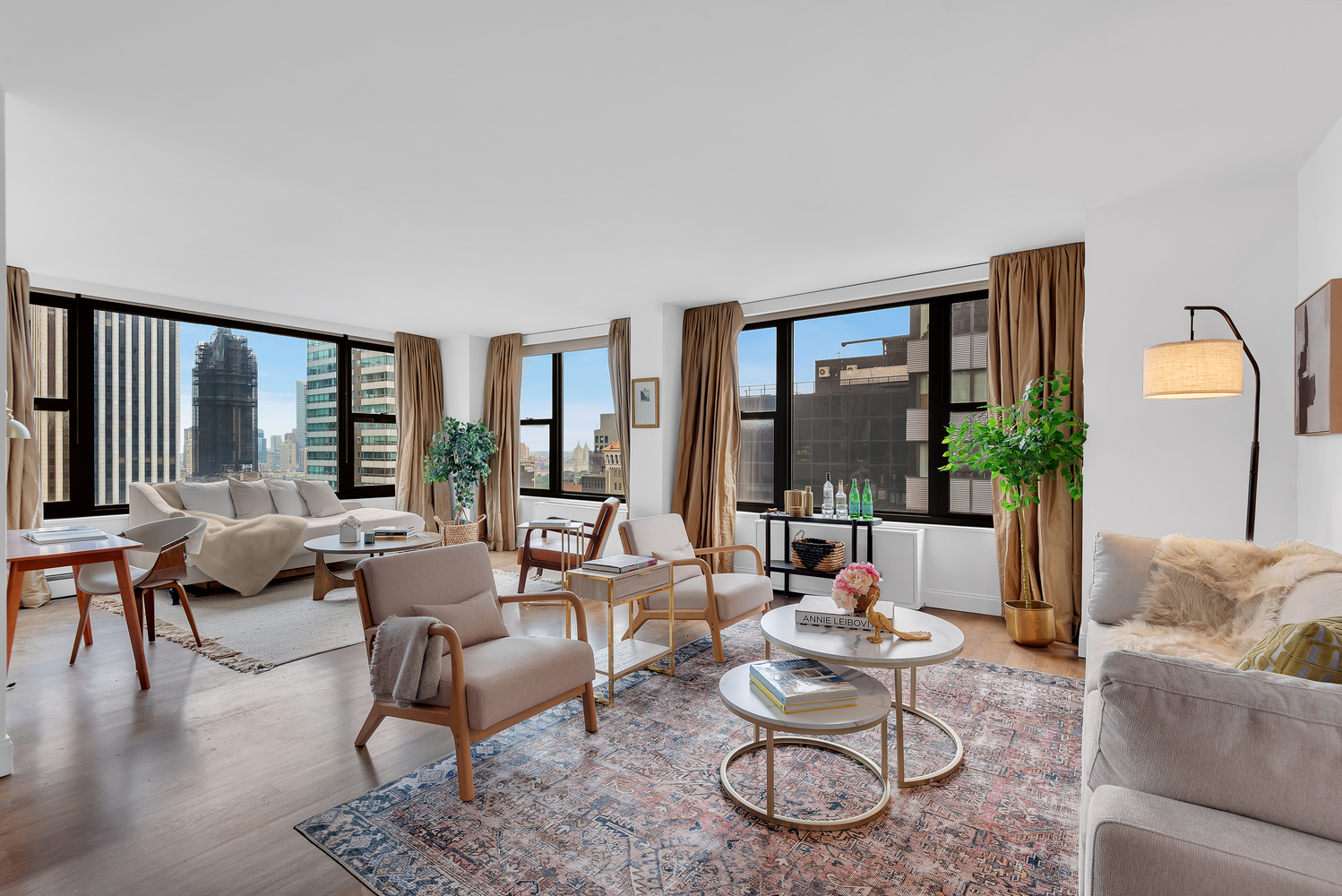 117 East 57th Street, Unit 35D Manhattan, NY 10022 - Photo 2 of 30 a living room with furniture and a large window