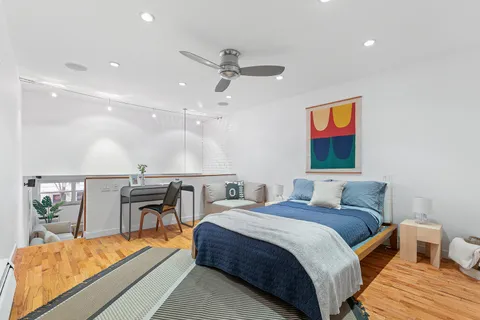 a bedroom with a bed and a table